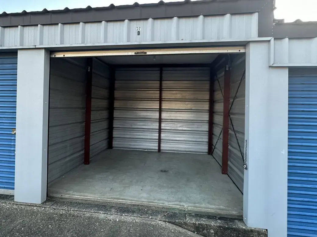 Open Cypress storage unit with a concrete floor and metal interior walls